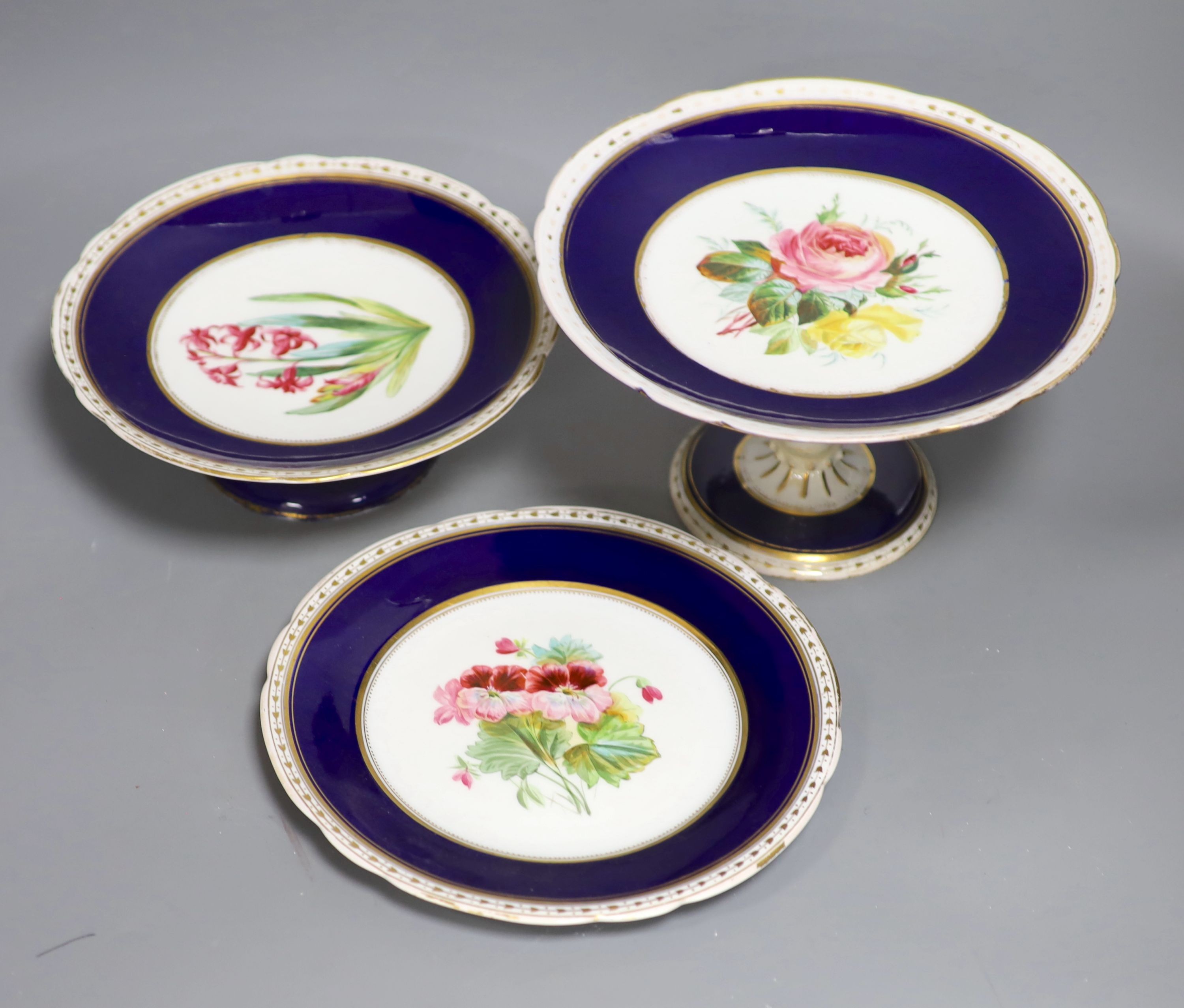 A Victorian porcelain flower painted dessert service, comprising eighteen plates and six cake stands